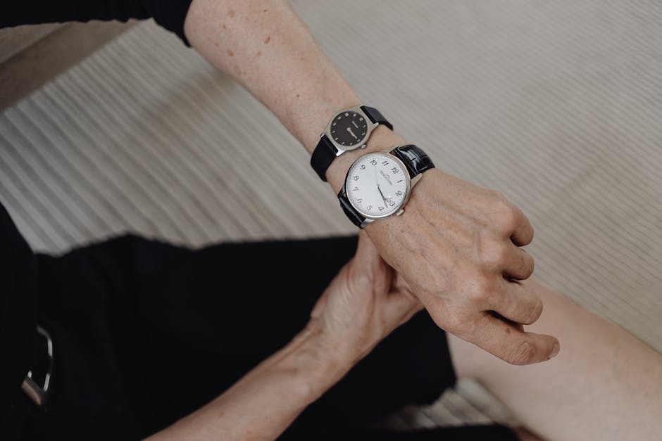 Elderly woman checking time on two wristwatches, symbolizing time management.
