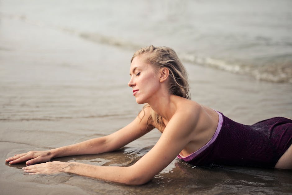 Beautiful woman in swimsuit enjoying a tranquil moment on the beach.