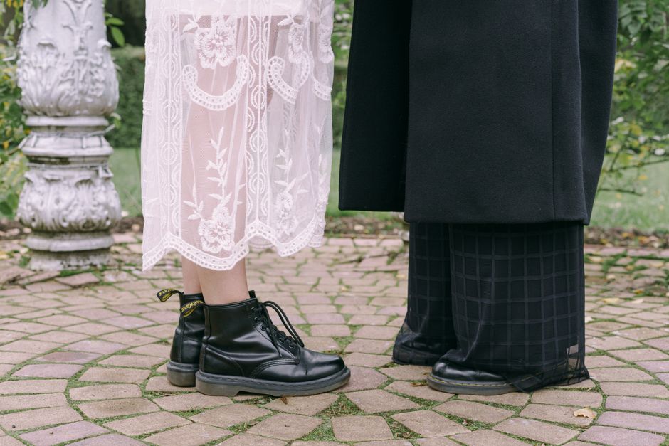 Close-up of a lesbian couple's footwear during their romantic outdoor wedding ceremony.