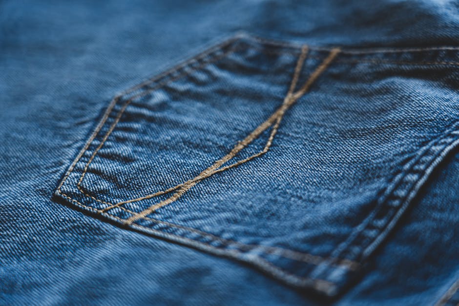 Macro shot of denim jeans showcasing intricate stitching detail.