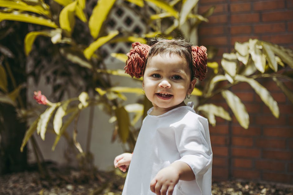 A happy child enjoying a sunny day outside in Panamá, surrounded by lush greenery.