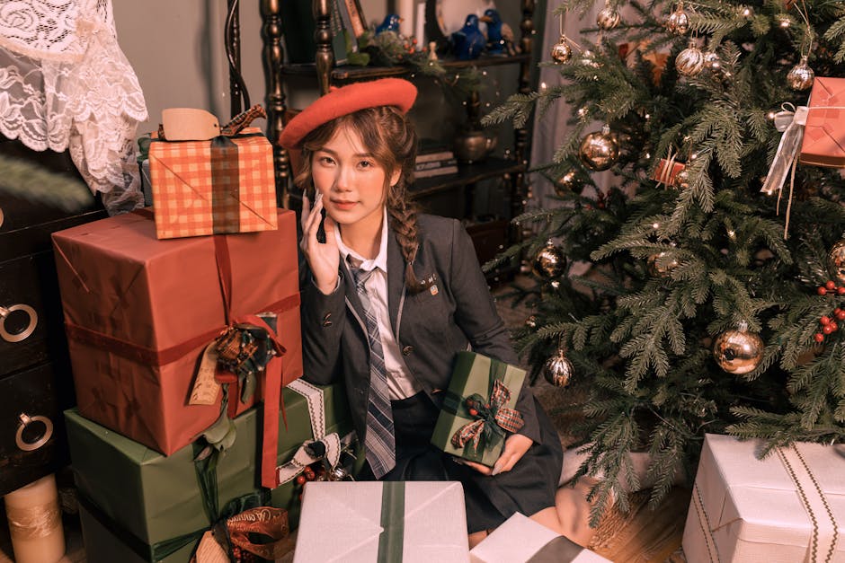 Young woman celebrating Christmas with gifts by a decorated tree.